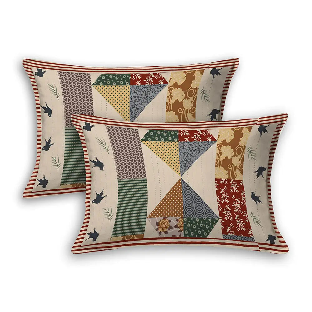 Two patchwork patterned pillows on a white background with Black bird brown base bedsheet