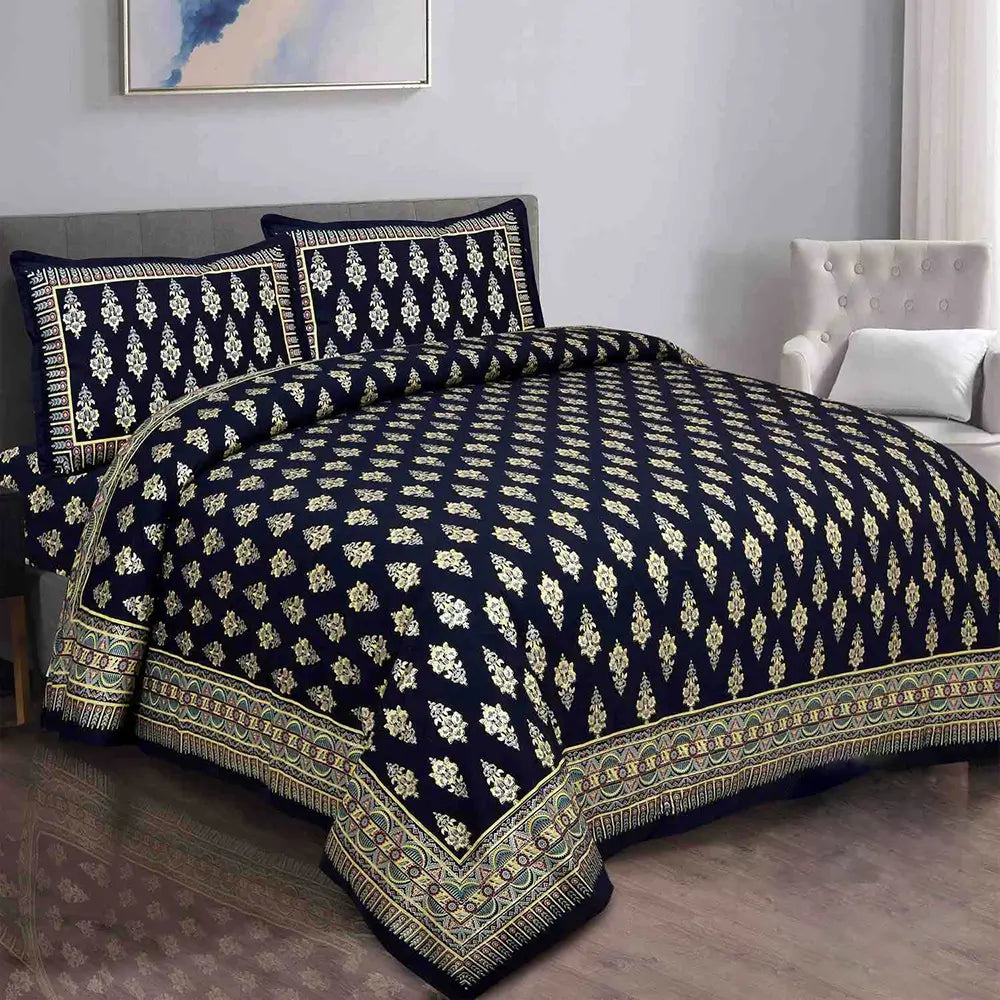 Navy blue and gold patterned bedspread on a bed in a bedroom setting.