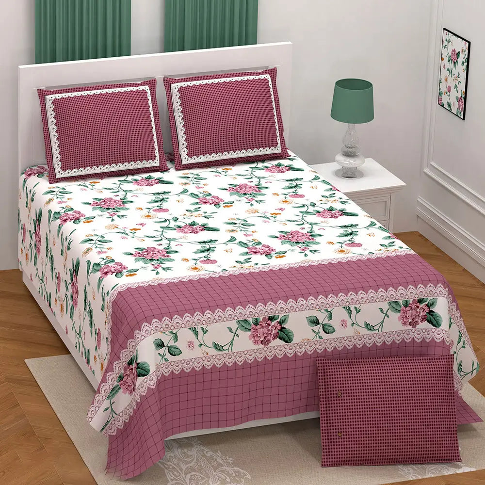 Floral bedspread set on a bed with matching pillows.