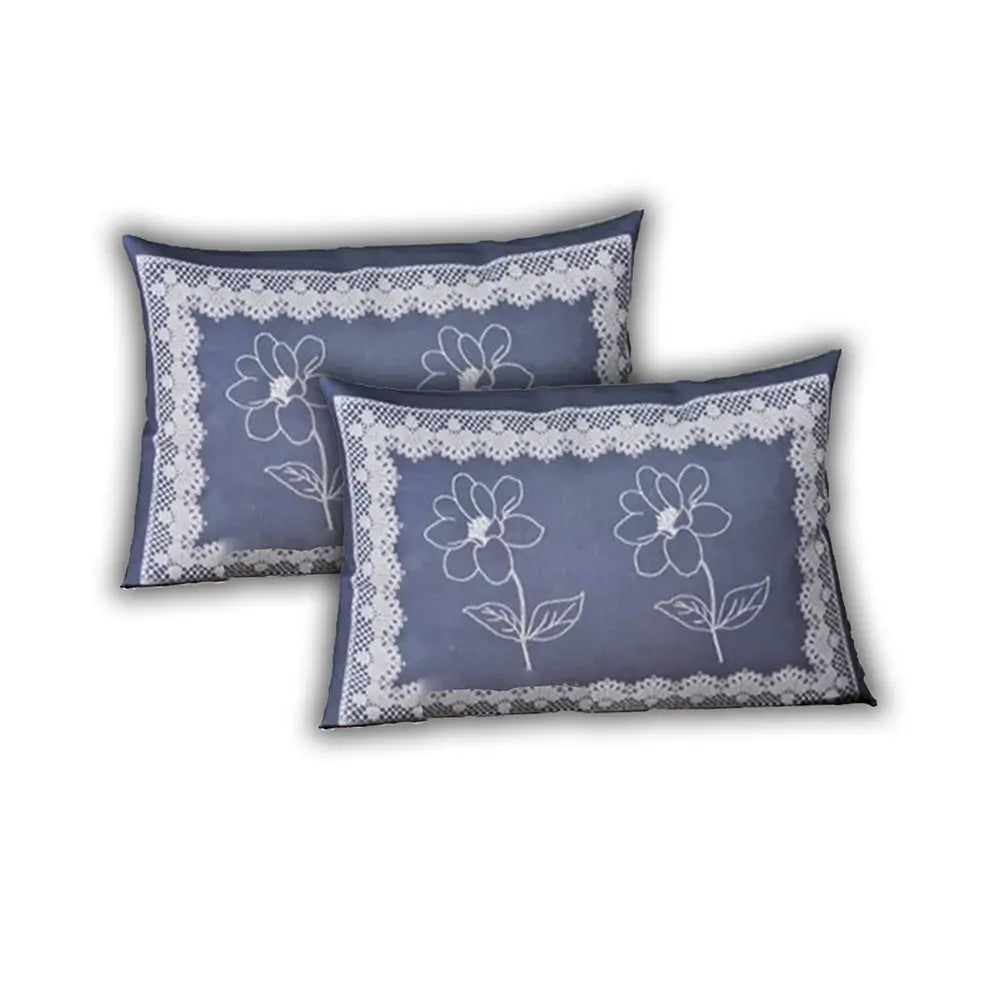 Two blue pillows with floral lace designs on a white background