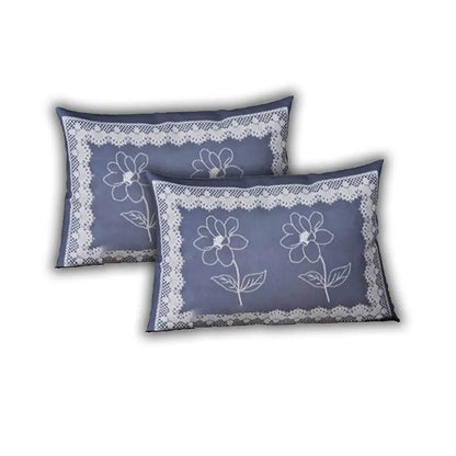 Two blue pillows with floral lace designs on a white background