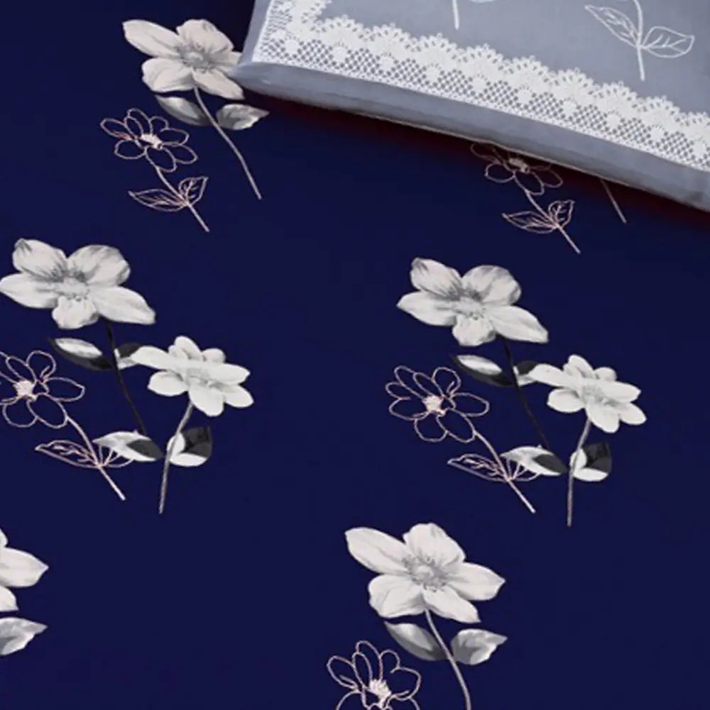 Floral pattern on a blue fabric with a white lace trim in the corner.