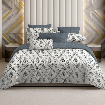 Bed with patterned bedding against a geometric wall design