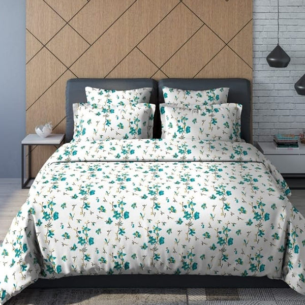 Floral patterned bedding set on a bed with a geometric headboard.