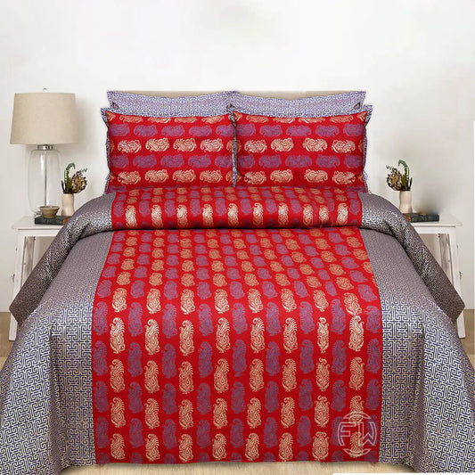 Red and gold patterned bedsheet on a bed with matching pillows in a bedroom setting.