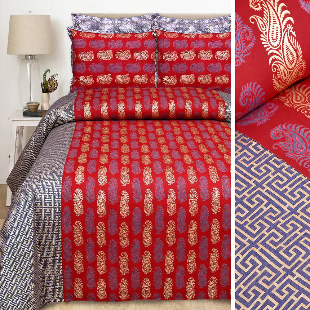 Red and blue patterned bedding set with a lamp and plant in the background.