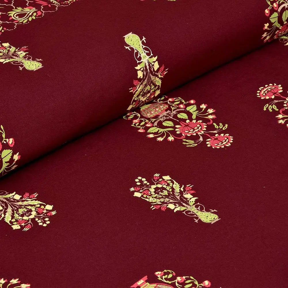 Maroon fabric with green and pink floral patterns bedsheet