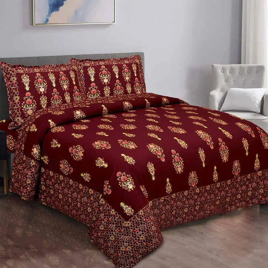 Maroon floral patterned bedsheet on bed with a gray headboard.