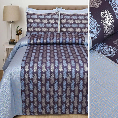 Patterned bedding set with paisley design on a bed in a bedroom setting.