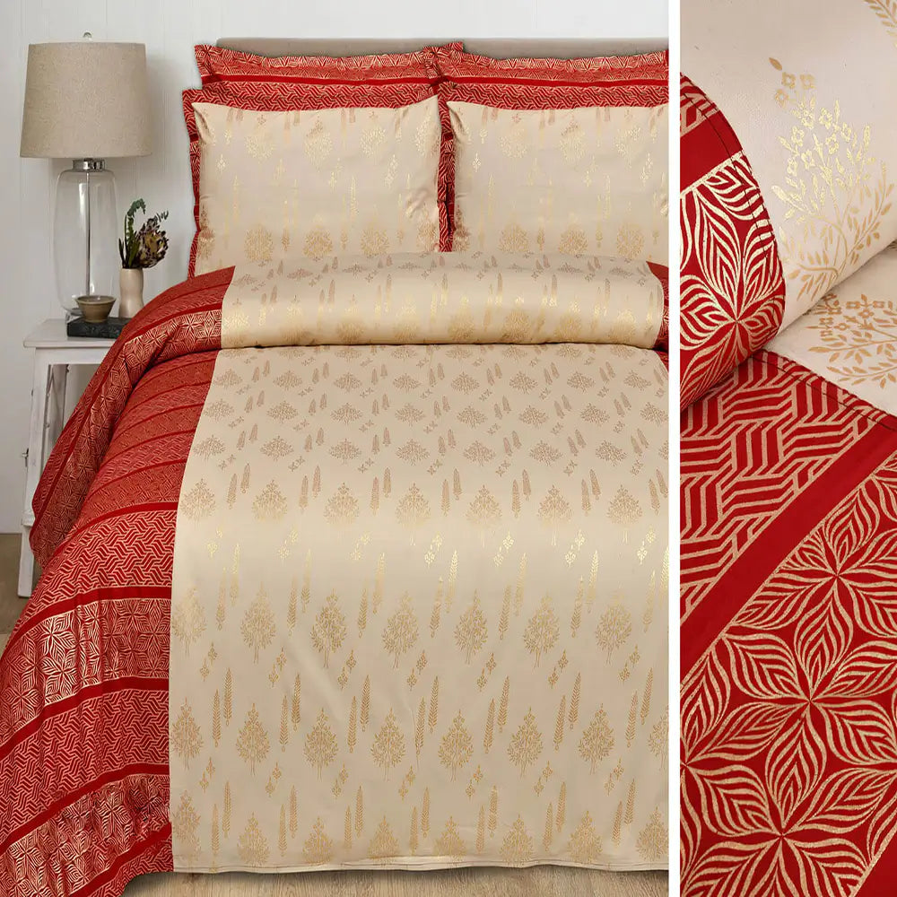 Red and beige patterned bedspread with matching pillows on a bed.