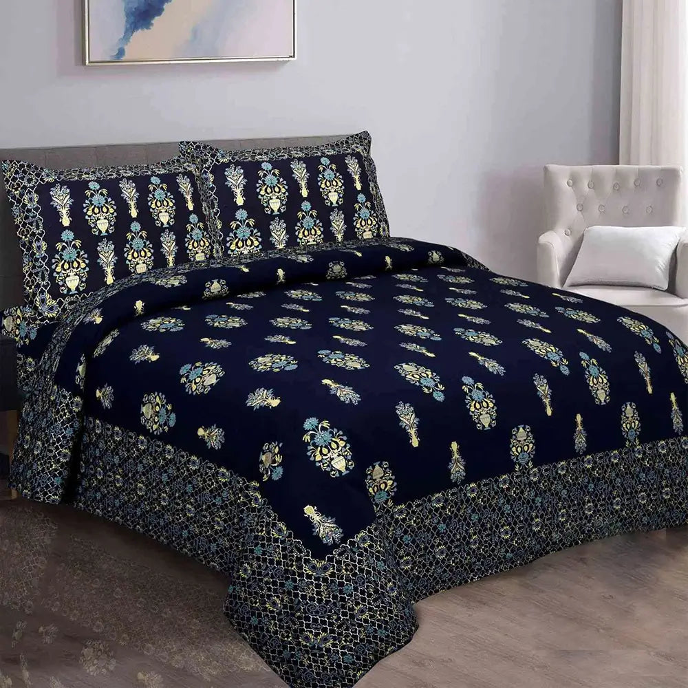 Navy blue floral patterned bedding set on a bed in a bedroom.