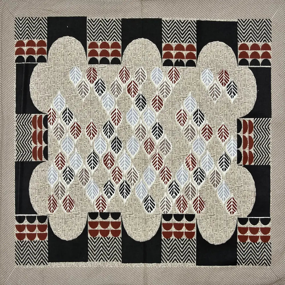 Decorative quilt with geometric pattern on a beige background