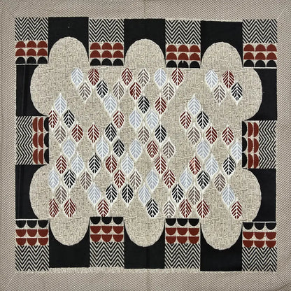 Decorative quilt with geometric pattern on a beige background