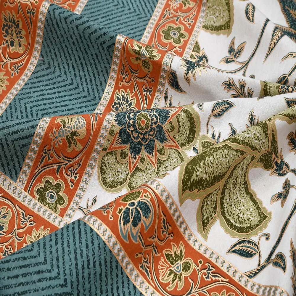 Patterned fabric with orange, green, and blue colors on a white background