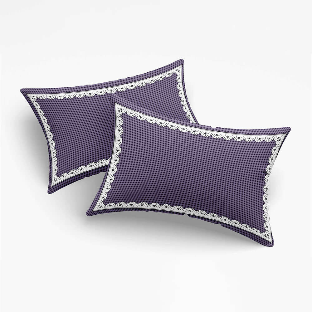 Two purple pillows with white lace trim on a white background